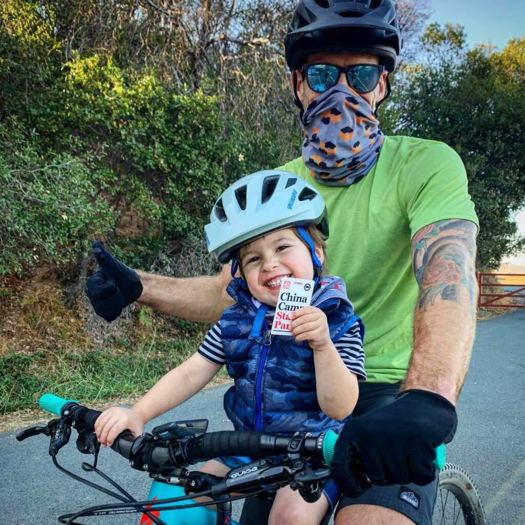Young cyclist and his dad show off his annual pass by Harriot Manley