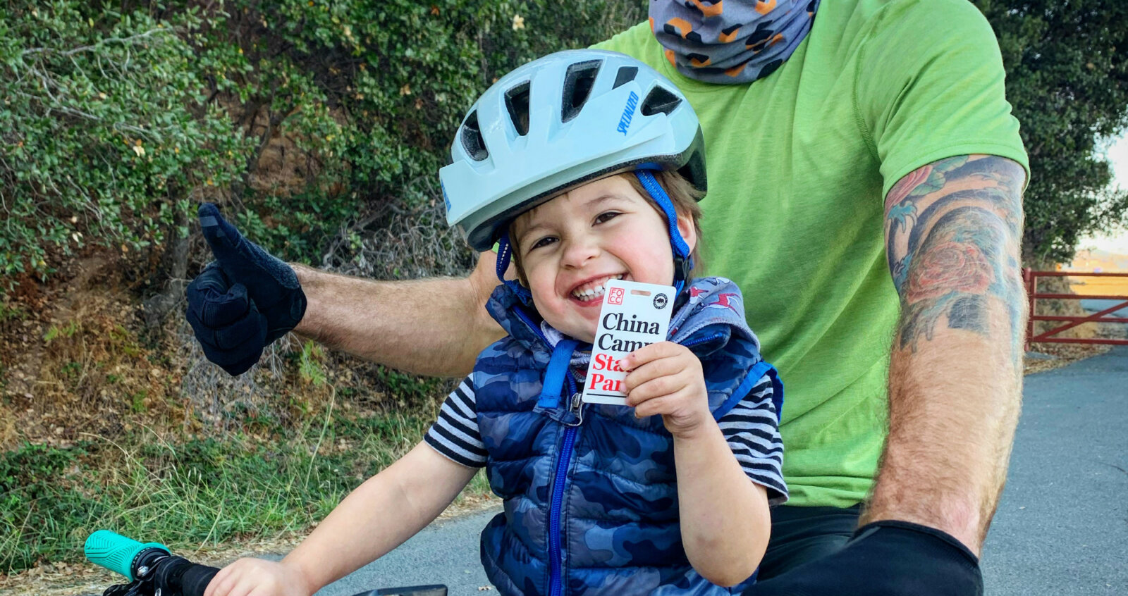Young cyclist and his dad show off his annual pass by Harriot Manley