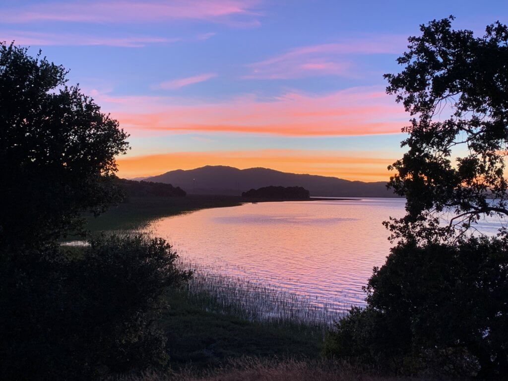 Sunset looking west across tidal wetlands at China Camp State Park by Harriot Manley