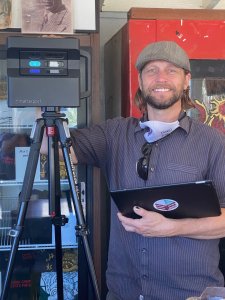 Michael Chandler of Third Eye Visuals stands next to his specialized video equipment in China Camp Cafe. Image by Harriot Manley
